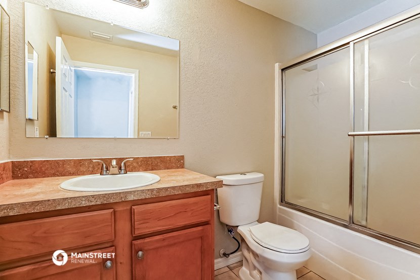 a bathroom with a sink toilet and a shower