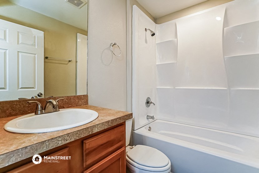 a bathroom with a sink and a shower and a toilet