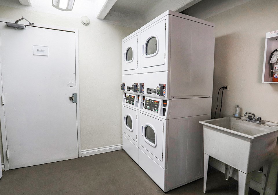 a kitchen with a washing machine and a sink