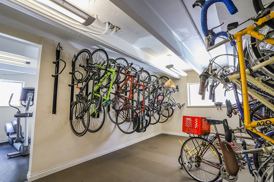 a rack of bikes hanging on a wall in a room