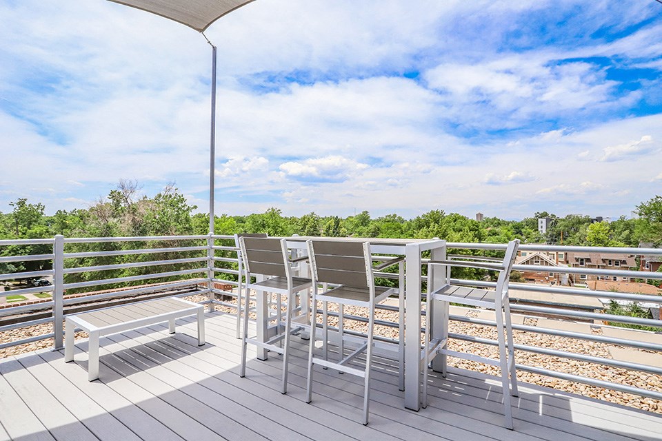 a balcony with two chairs and a table on it