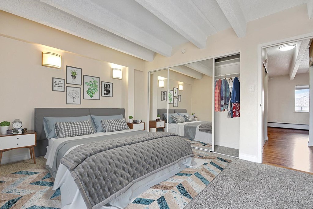 a bedroom with two beds and a mirrored closet