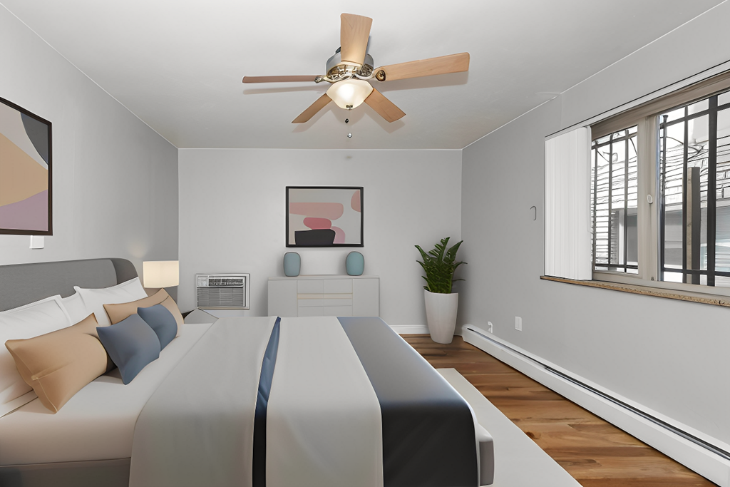 a bedroom with a large bed and a ceiling fan