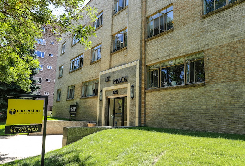 a large brick building with a sign in front of it