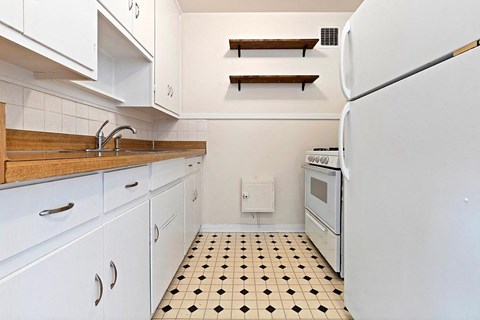 a kitchen with a stove refrigerator and a sink