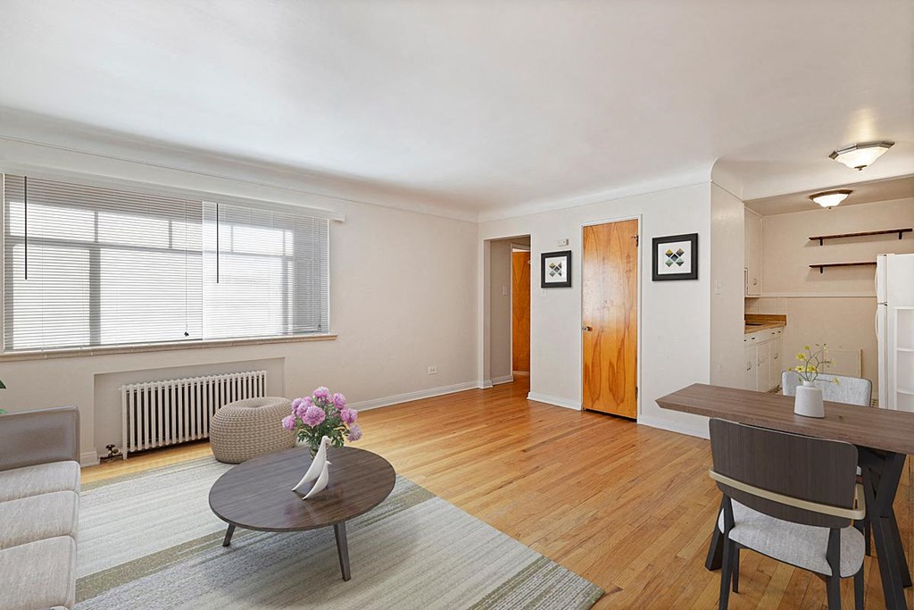 a living room and dining room with a table and chairs