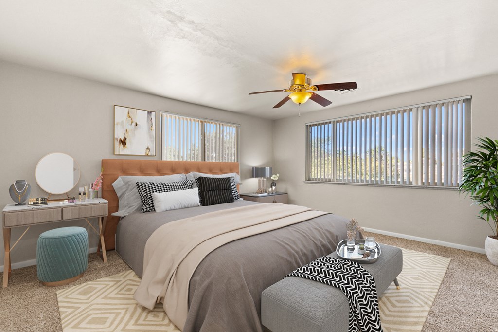 a bedroom with a large bed and a ceiling fan