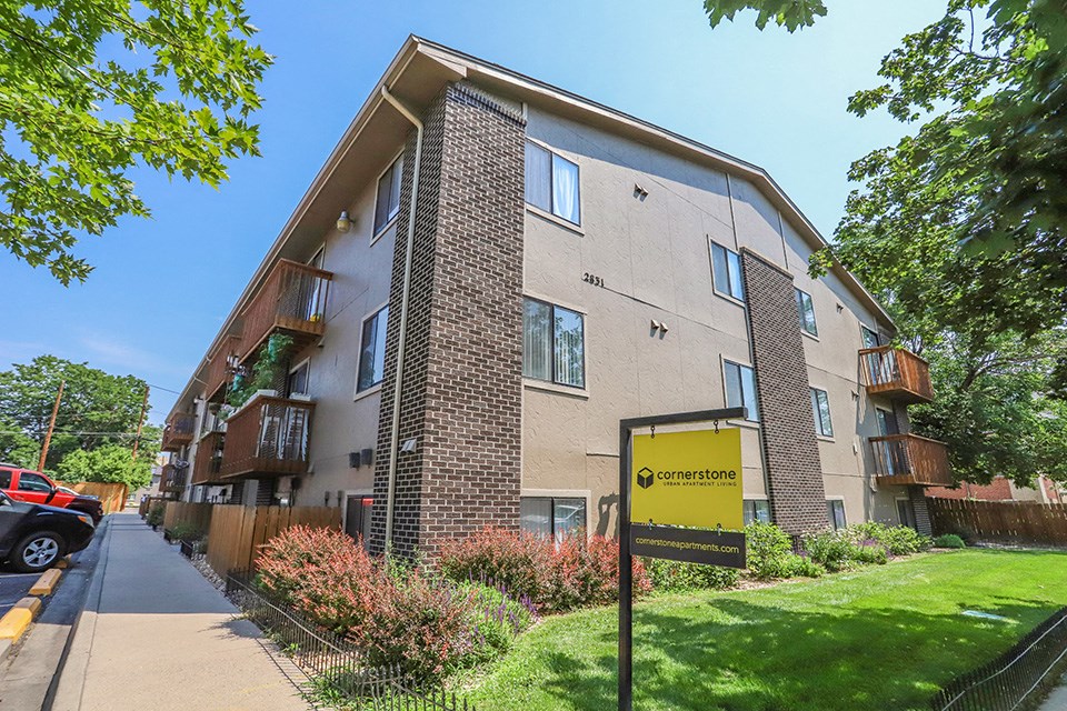 an apartment building with a yellow sign in front of it