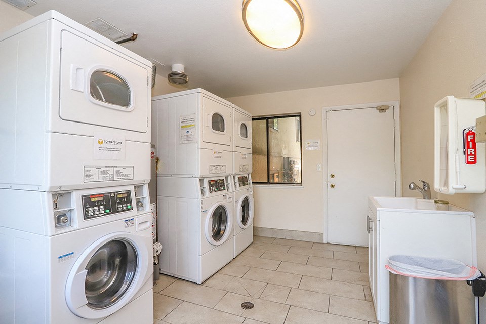 a washer and dryer in a laundry room with washing machines