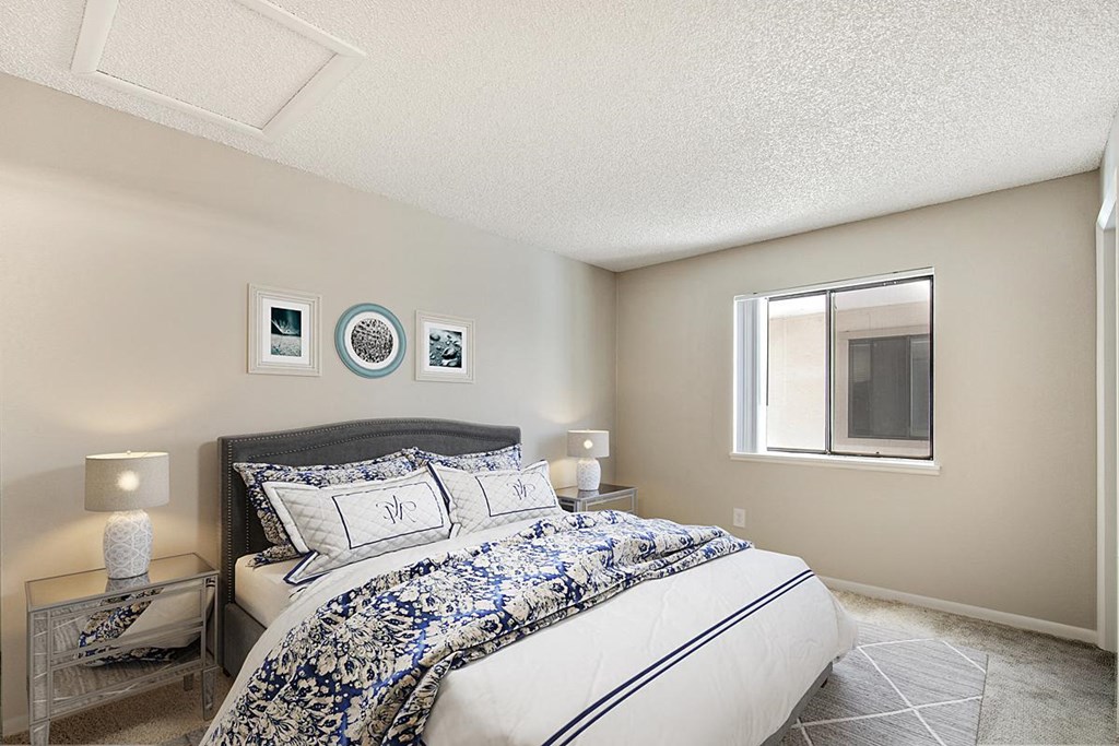 a bedroom with a bed and a window