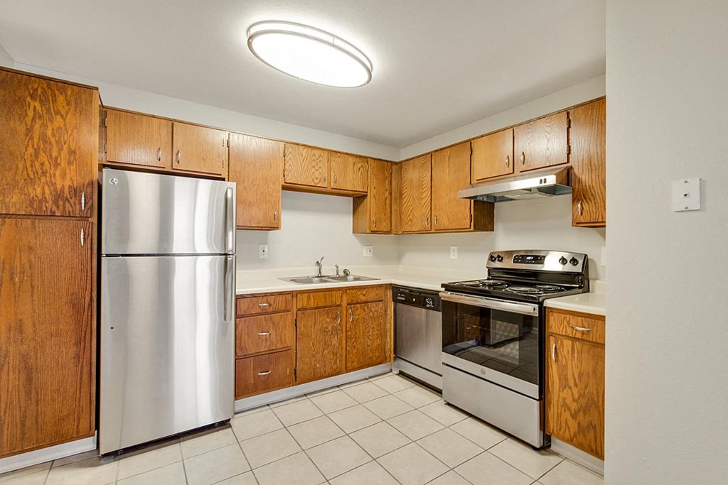 a kitchen with stainless steel appliances and wooden cabinets