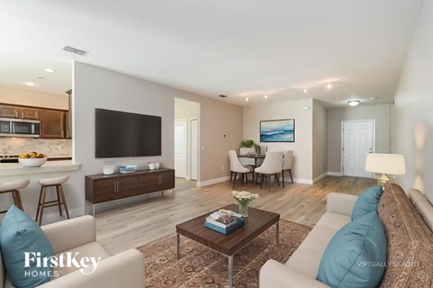 A modern living room with a large couch and a television.