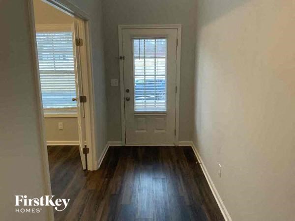 an empty room with a door and a window