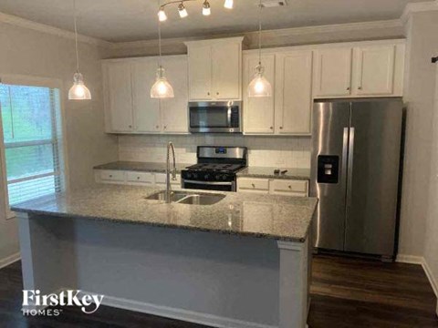a kitchen with white cabinets and a counter top