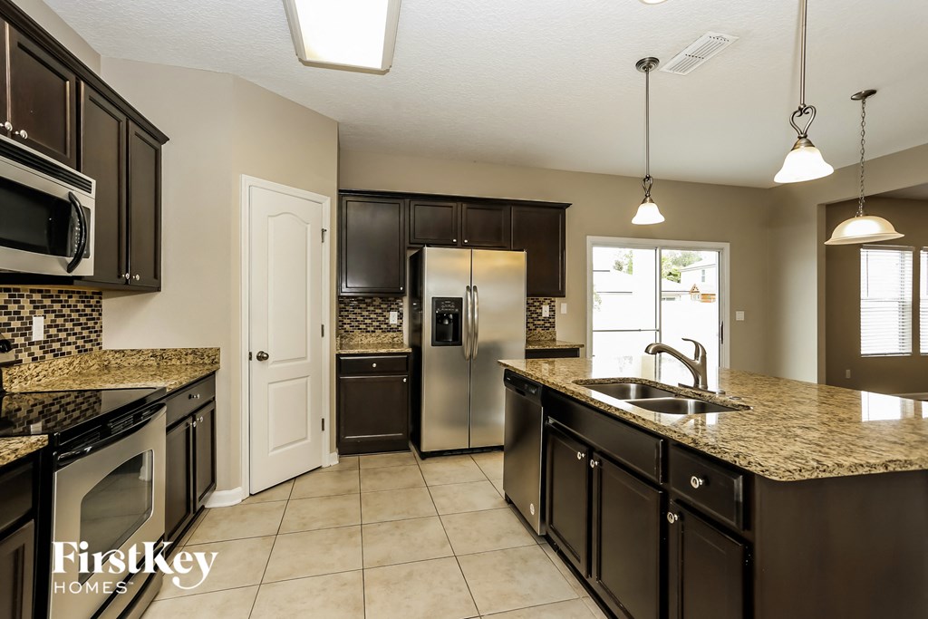 a kitchen with stainless steel appliances and granite counter tops