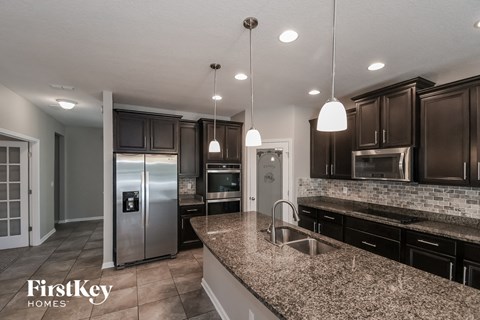 a kitchen with granite counter tops and stainless steel appliances