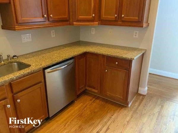 A kitchen with wooden cabinets and granite countertops.