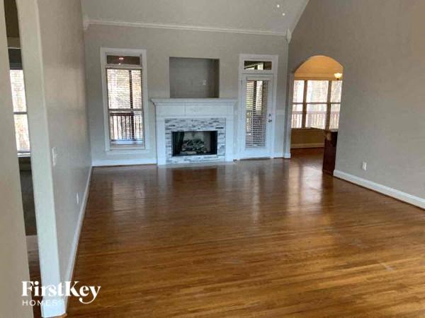 A living room with a fireplace and a flat screen TV.