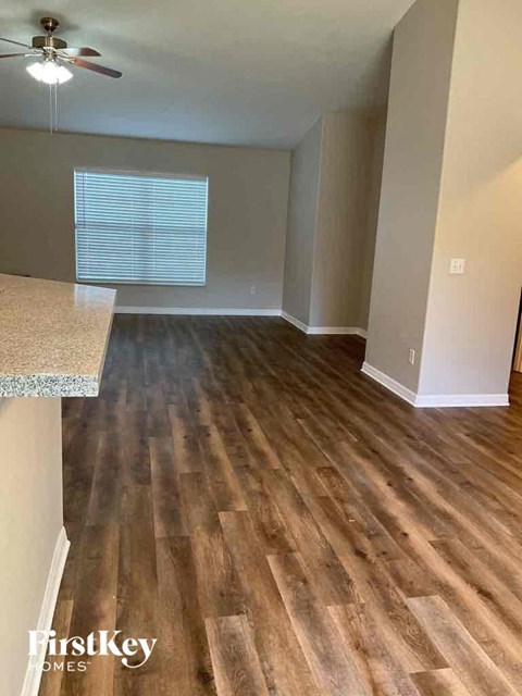 an empty kitchen and living room with wood flooring