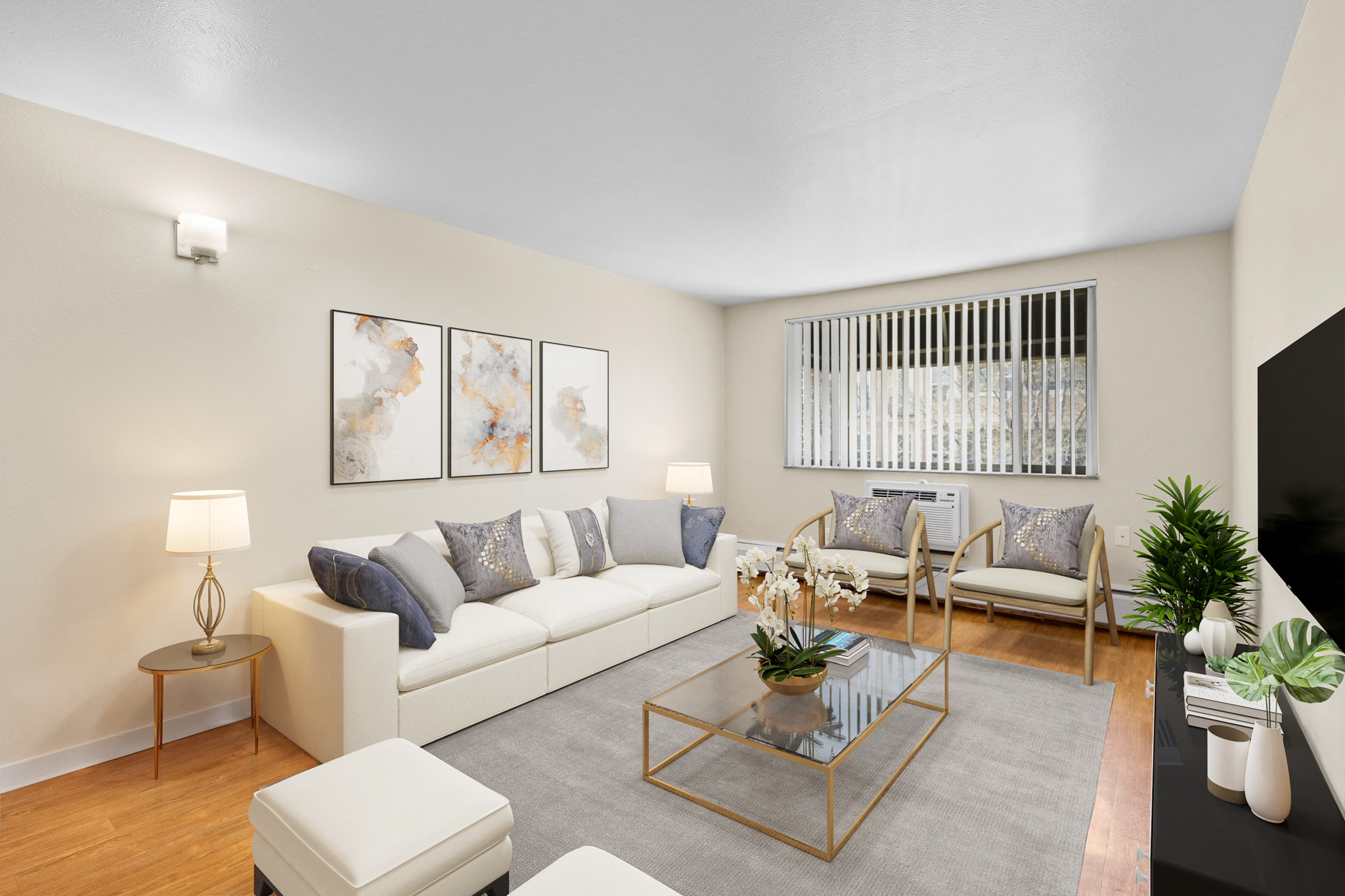a living room with white furniture and a glass coffee table