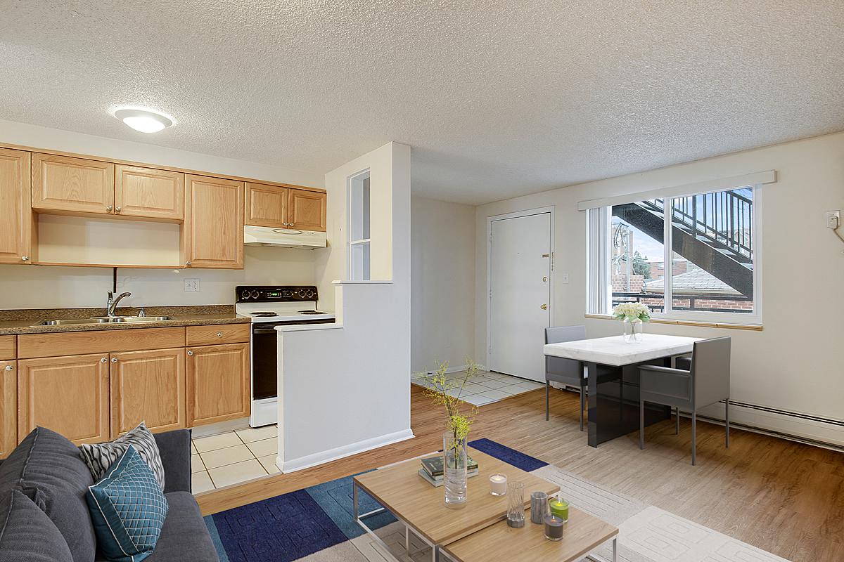 a living room with a kitchen and a table