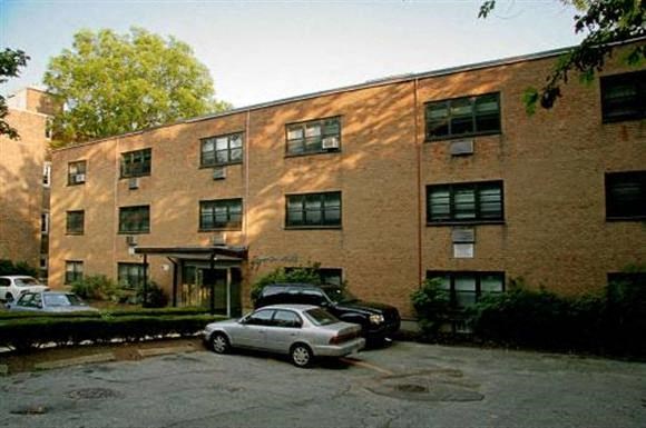 a brick building with cars parked in front of it