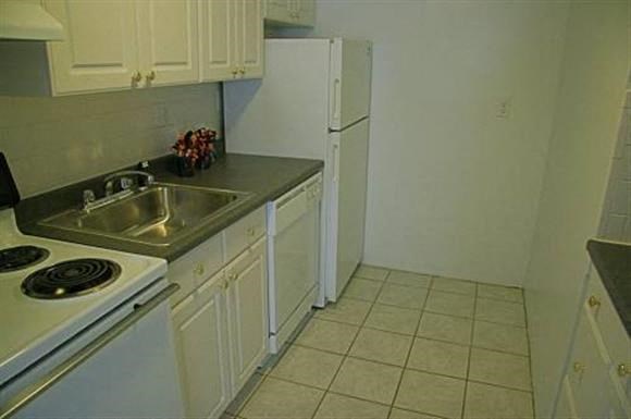 a kitchen with a sink and a refrigerator