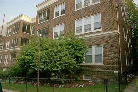 a brick building with a tree in front of it