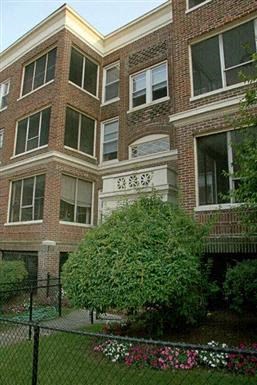 a large brick building with a tree in front of it
