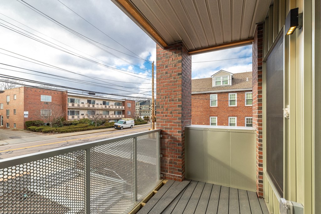 the view of the street from the balcony of a apartment building