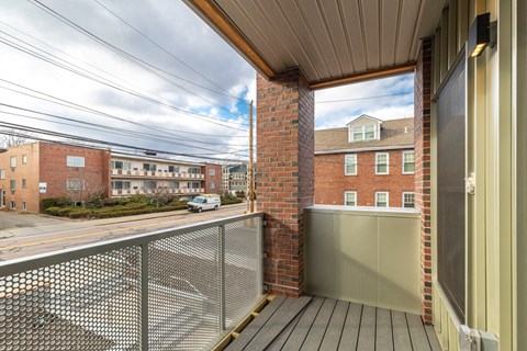 the view of the street from the balcony of a apartment building