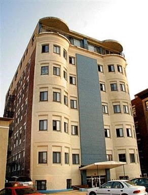 a tall building with a car parked in front of it