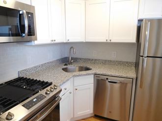 Kitchen with Stainless Appliances, Gray Granite Counters and White Cabinets