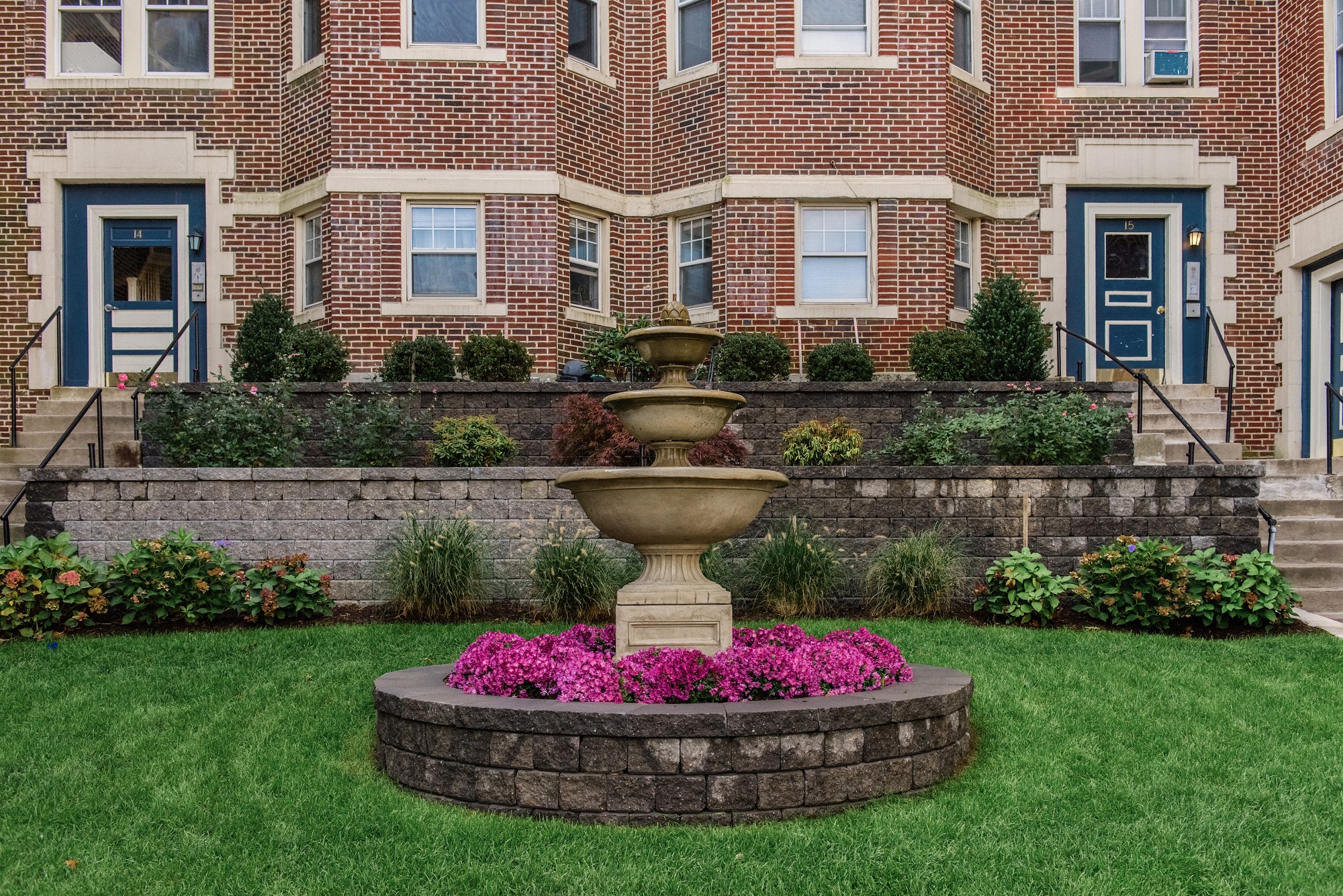 Fountain with Pink Flowers, Plants and Grass