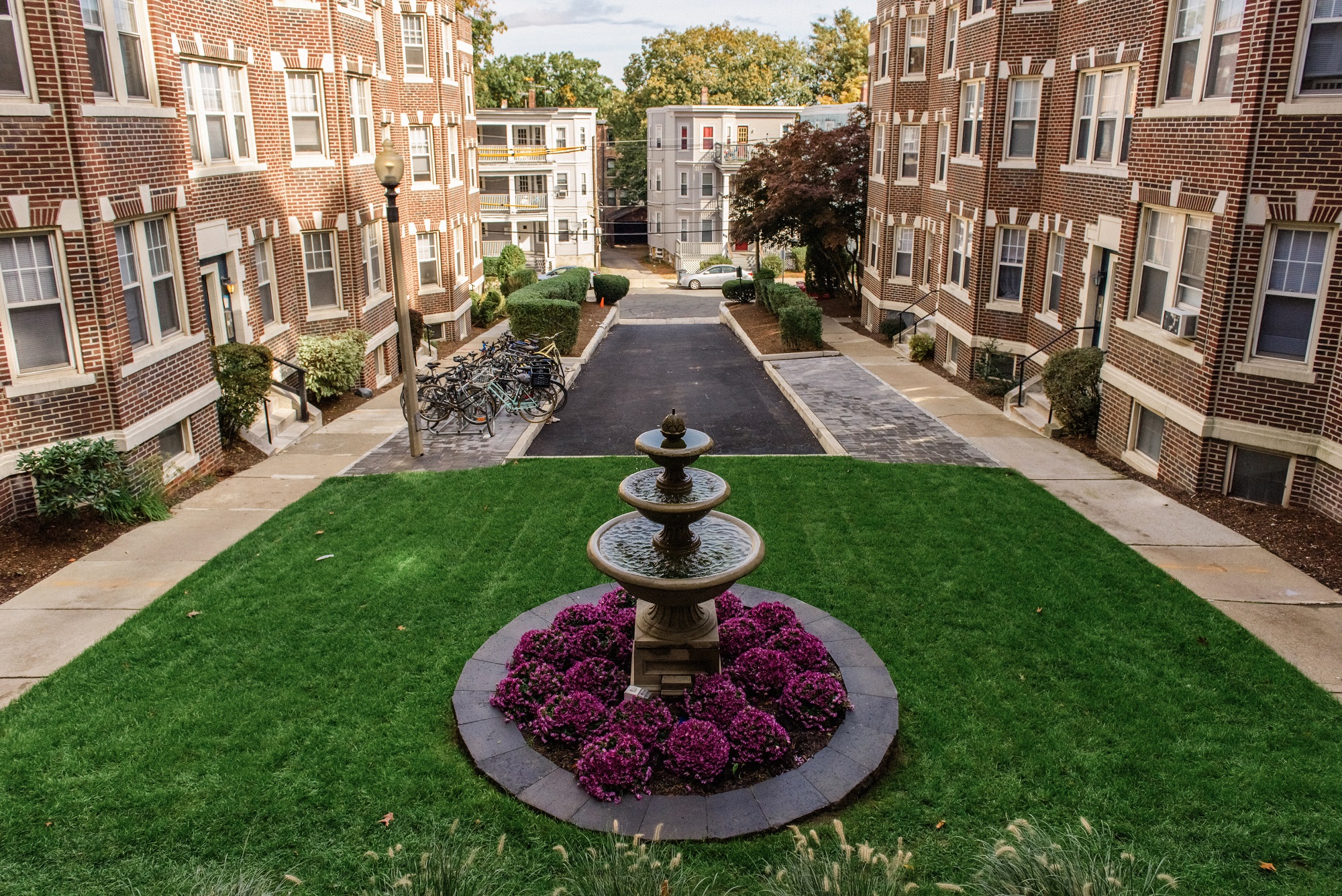 View of Courtyard looking down from the Building, fountain with Grass, Emergency Lane and Bike Rack