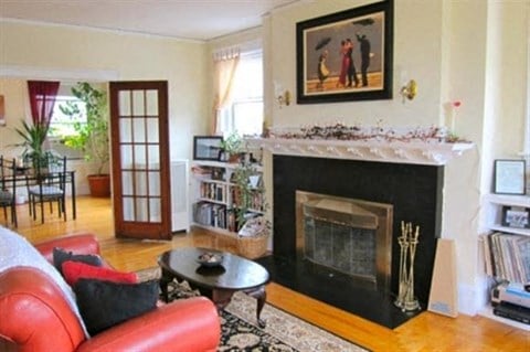 a living room with a fireplace and a red couch