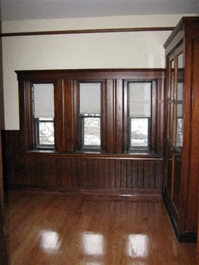 a living room with wood floors and windows