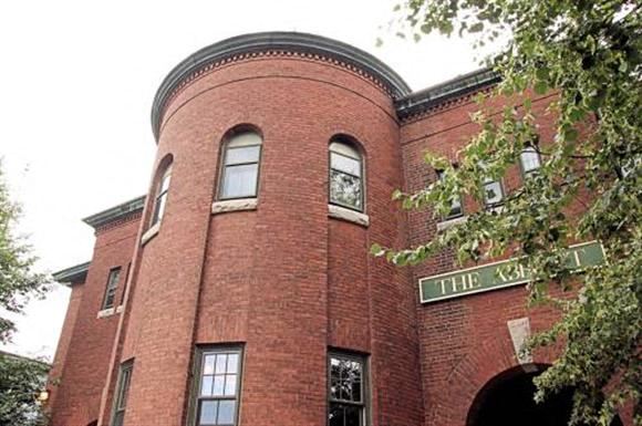 a brick building with a clock on the front of it