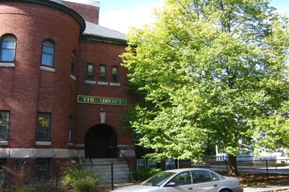 a car parked in front of a red brick building