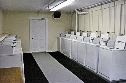 a row of white washing machines in a room