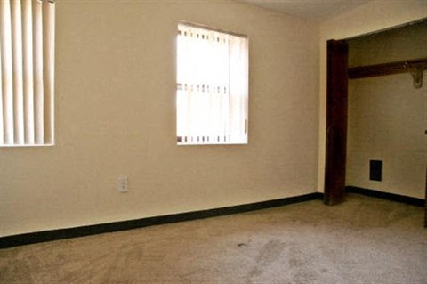 an empty room with a door and a window