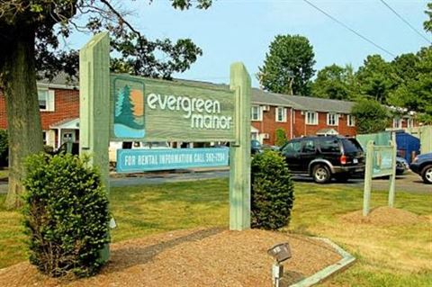 a sign for evergreen magic in front of a parking lot