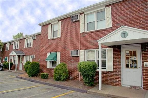 a red brick apartment building with a white door