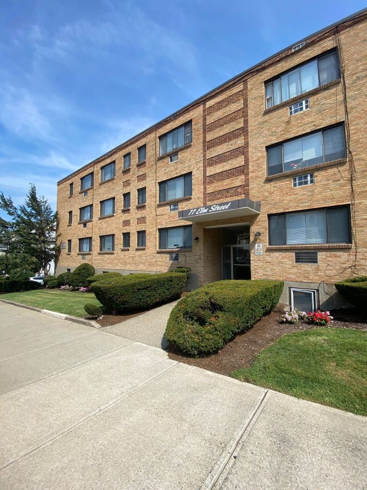 a brick building with a sidewalk in front of it