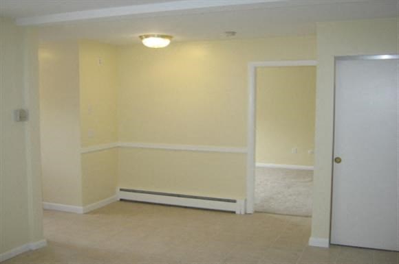 an empty room with white walls and a door