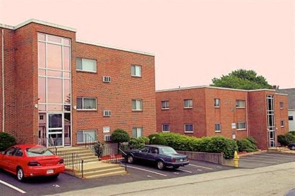 a red brick building with cars parked in front of it