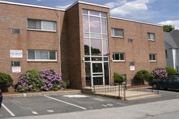 a red brick building with a large glass door