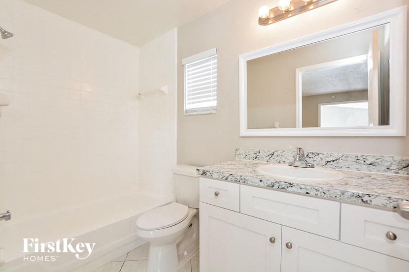 a bathroom with a sink toilet and a bath tub