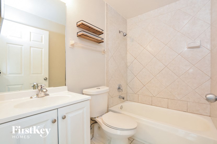 a bathroom with a sink toilet and a tub