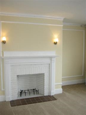 a living room with a fireplace and a rug